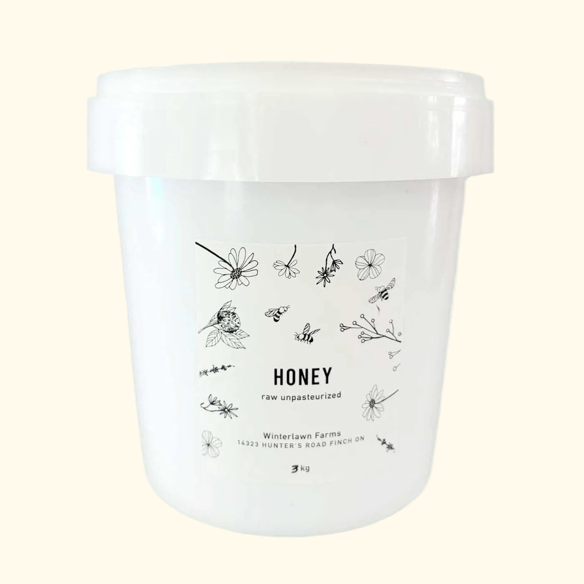 A white plastic tub of Winterlawn Farms Raw Unpasteurized Honey.