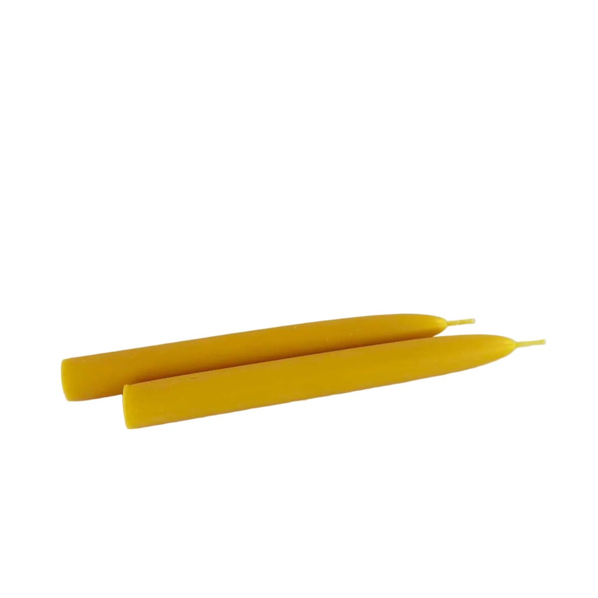Two yellow taper candles lying parallel to each other on a plain white surface.