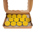 An open brown cardboard gift box with a clear window lid, containing ten small yellow tea light candles arranged in two rows on white tissue paper.