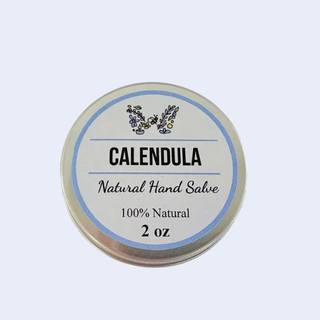 A round silver tin of Calendula Natural Hand Salve with a white and blue label, set against a plain off-white background.