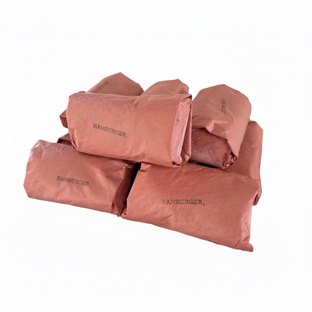 Five hamburger wraps wrapped in pink paper with a brown paper band, stacked on a silver metal tray.